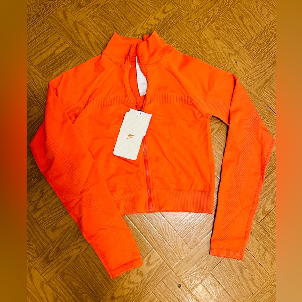 Orange fitted zip up Fabletics tags on